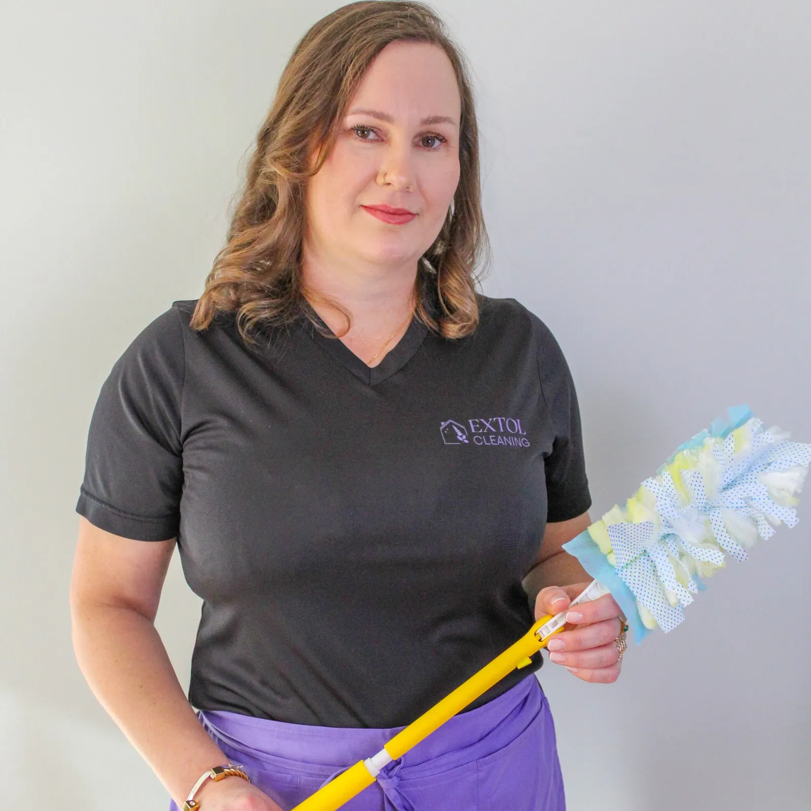 Tamiris Kempner with a duster before a move-in cleaning