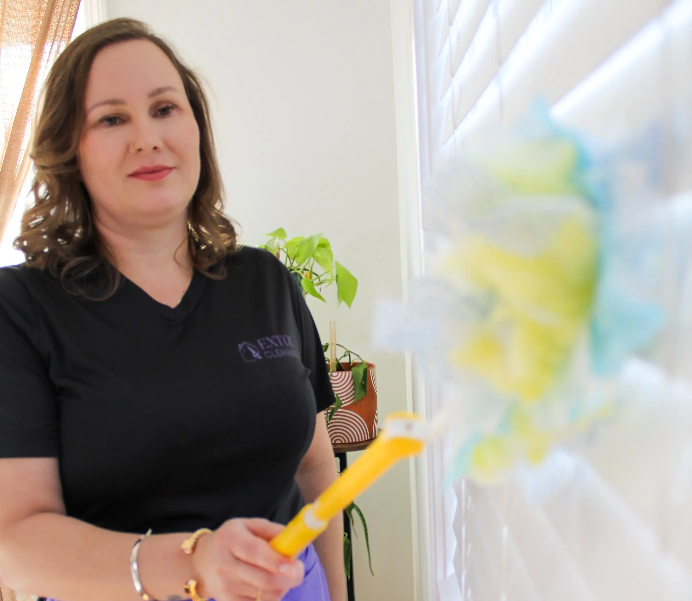 Extol Cleaning dusting by a window in an empty home before a move