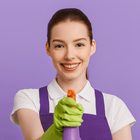 Smiling cleaning staff woman in purple uniform holding a spray bottle